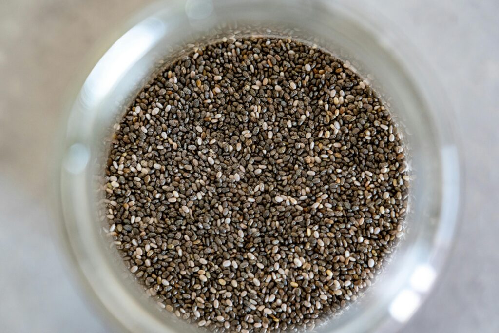 High-angle view of chia seeds in a glass jar, perfect for healthy cooking.
